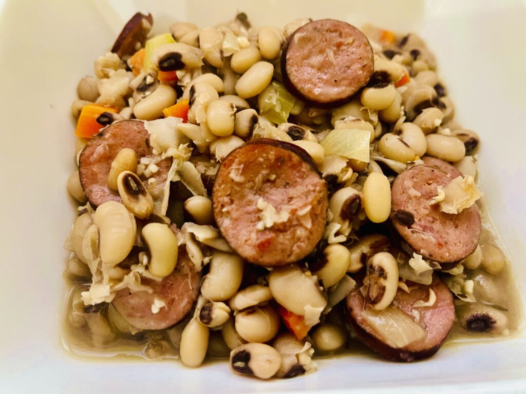 Black-eyed peas cooked with andouille sausage, onions, and vegetables
