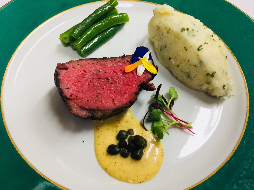Medium-rare beef tenderloin with mashed potatoes, green beans, and mustard caper sauce plated by Chef Wendell Plated Soul