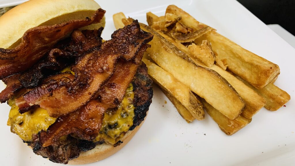 Chef Wendell White’s bacon cheddar burger with homemade Idaho russet fries demonstrating simple cooking done with proper seasoning, texture, and heat control