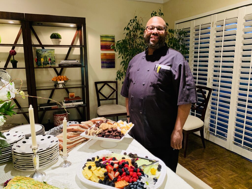 Chef Wendell White preparing and serving a private catering event while reflecting on balancing creativity, business, and family.