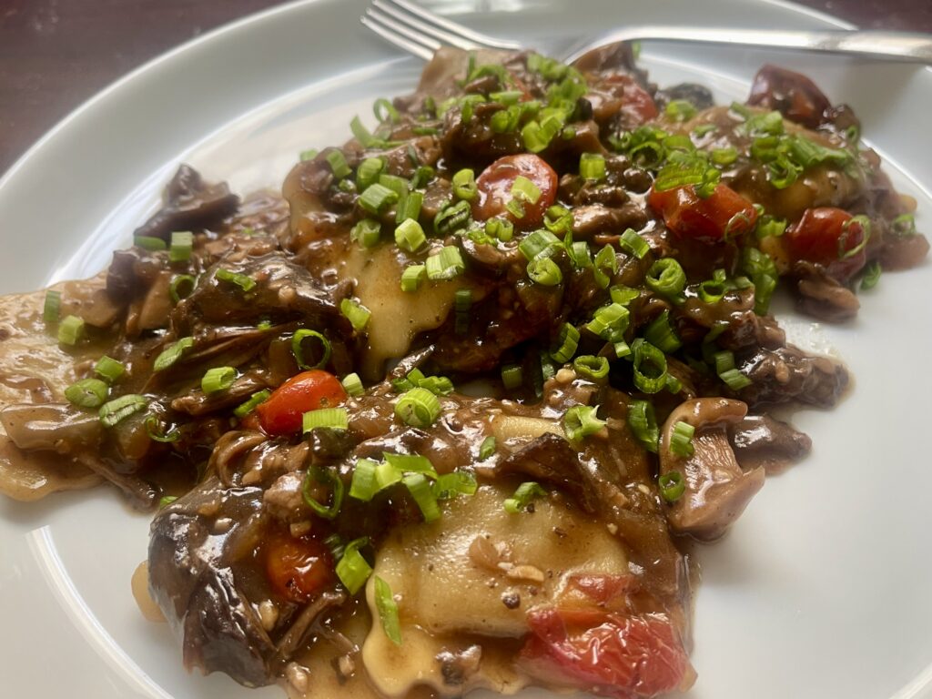 Store-bought short rib ravioli topped with red wine braised beef short ribs, mushrooms, cherry tomatoes, and fresh chives.